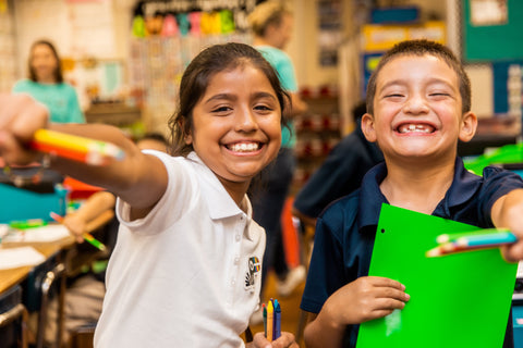 2 young kids having fun at school with their Yoobi school supplies