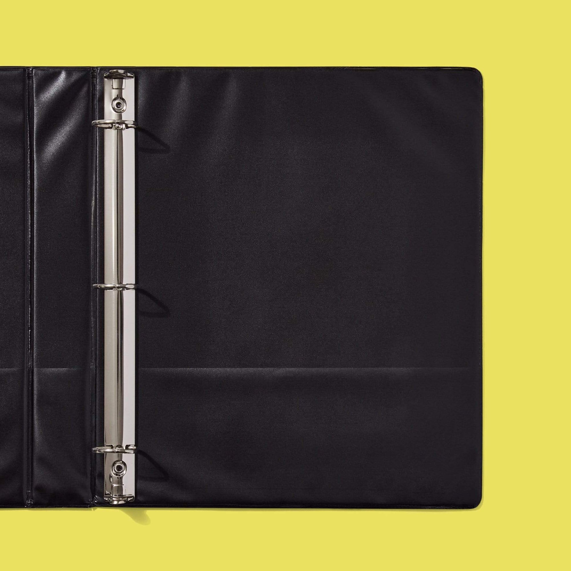 close up of inside of black Avengers icon binder showing inside pockets and D-ring detail